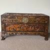 Vintage carved camphor wood blanket chest with detailed scenic carving